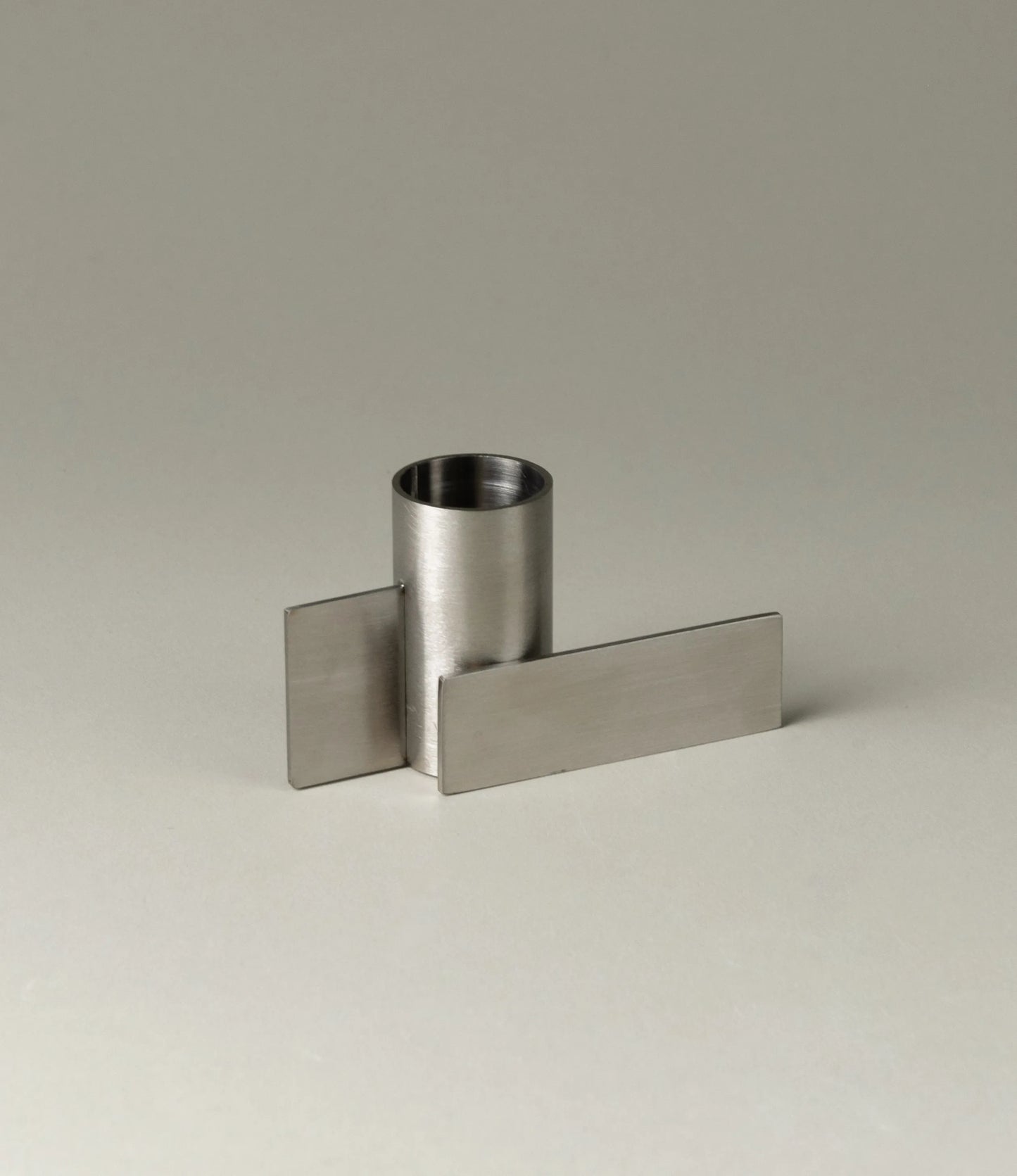 Icon Iysestage 01 from Stences is a candleholder made for taper candles. This picture shows the chrome variant of this item. The steel material has a brushed surface which emphasize the soft geometric shapes of the product in question.