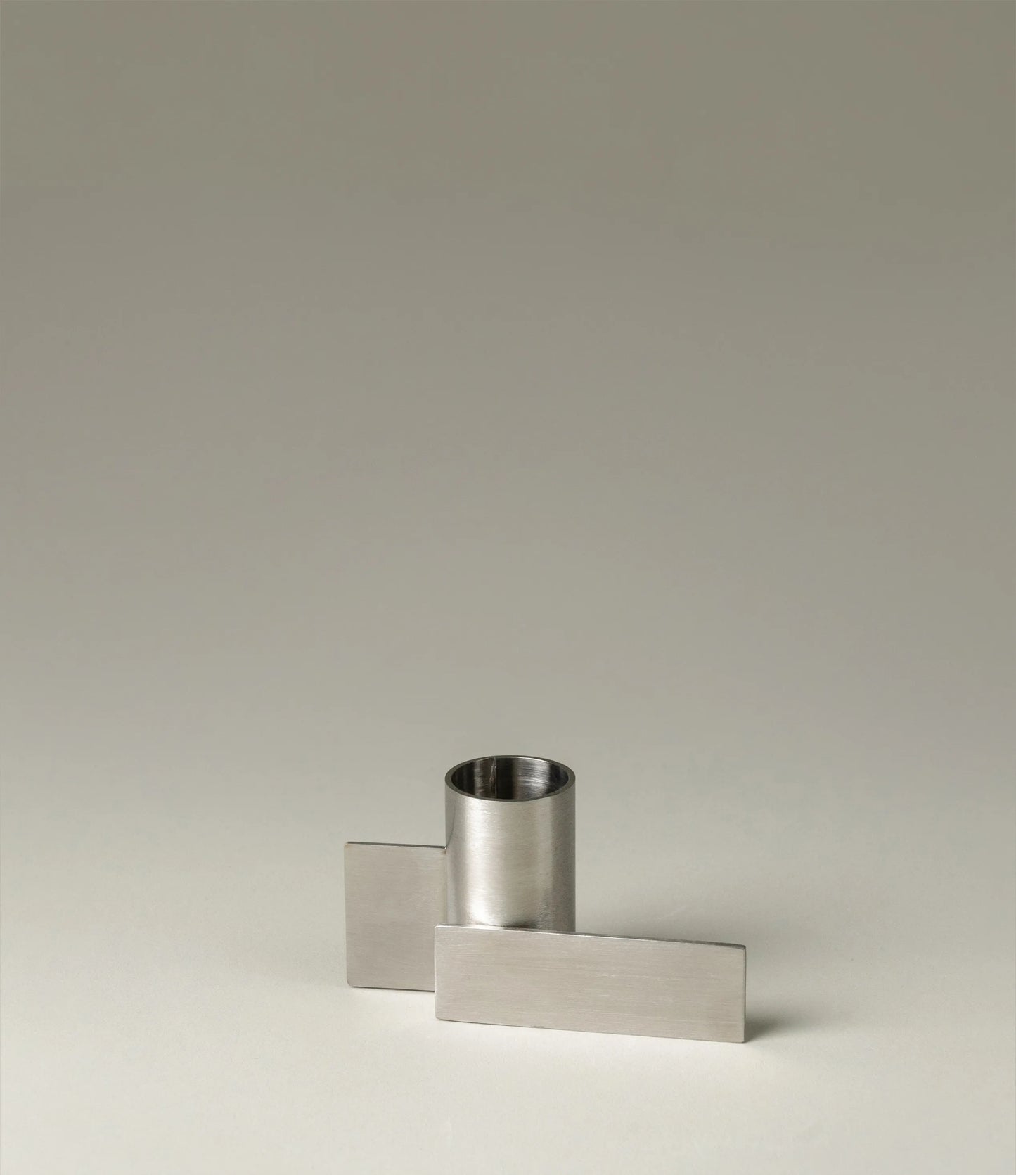 Icon Iysestage 01 from Stences is a candleholder made for taper candles. This picture shows the chrome variant of this item. The steel material has a glossy surface which emphasize the soft geometric shapes of the product in question.