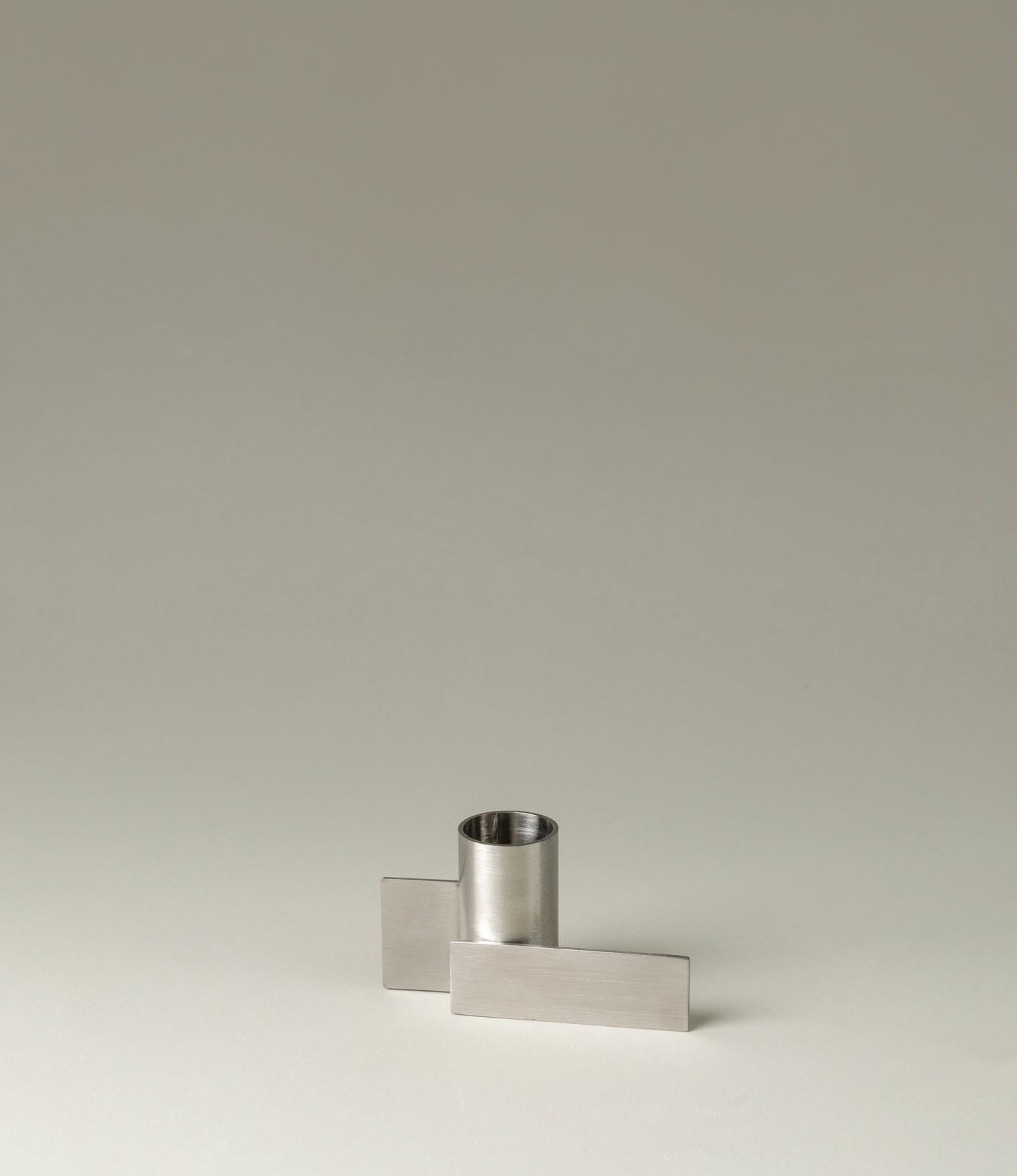 Icon Iysestage 03 from Stences is a candleholder made for taper candles. This picture shows the chrome variant of this item. The steel material has a glossy surface which emphasize the soft geometric shapes of the product in question.