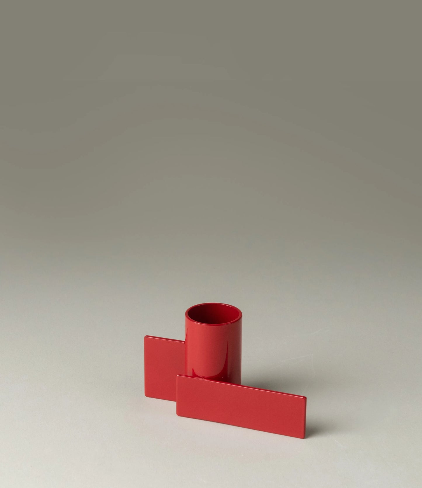Icon Iysestage 01 from Stences is a candleholder made for taper candles. This picture shows the red variant of this item. The steel material has a glossy surface which emphasize the soft geometric shapes of the product in question.