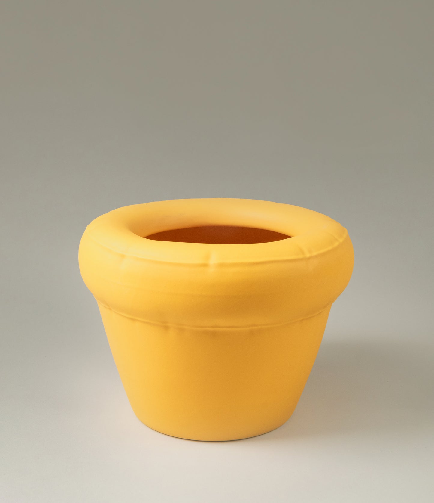 Homestudyo planter pierre in Yolk (yellow) color. The perpective of the shot is a zoom. the planter design looks like and inflatable ballon although it is made of ceramics. Perfect addition for any maximalist interior
