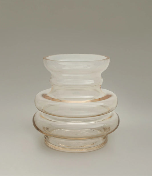 Curve Vase Gul from Stences is a glass vase which has a hint of beige color on it. Still very transparent and glossy.