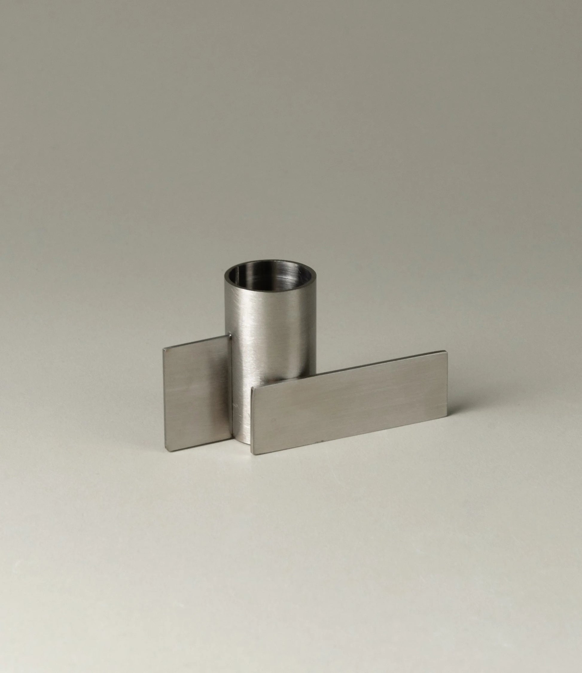 Icon Iysestage 01 from Stences is a candleholder made for taper candles. This picture shows the chrome variant of this item. The steel material has a brushed surface which emphasize the soft geometric shapes of the product in question.