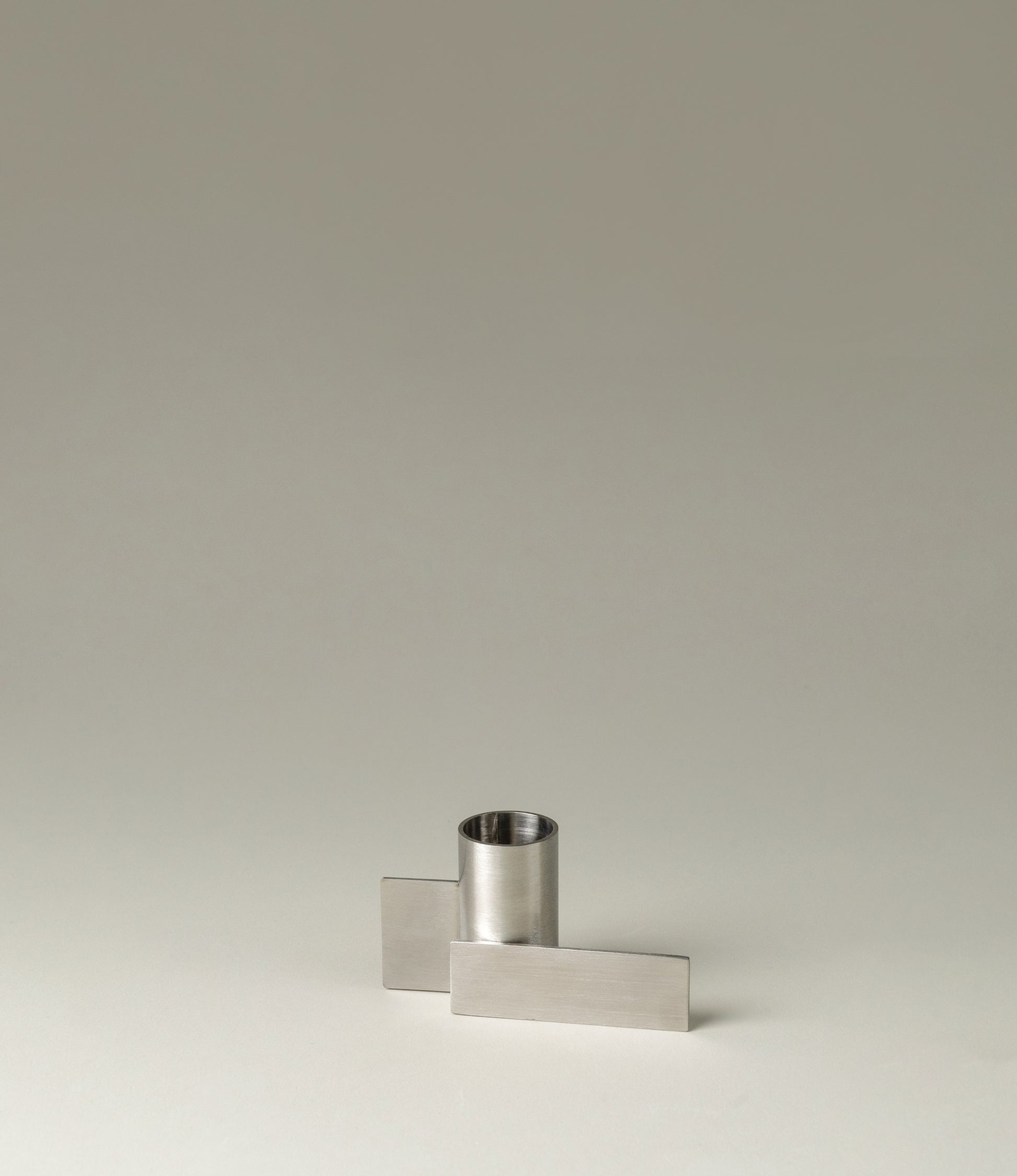 Icon Iysestage 03 from Stences is a candleholder made for taper candles. This picture shows the chrome variant of this item. The steel material has a glossy surface which emphasize the soft geometric shapes of the product in question.